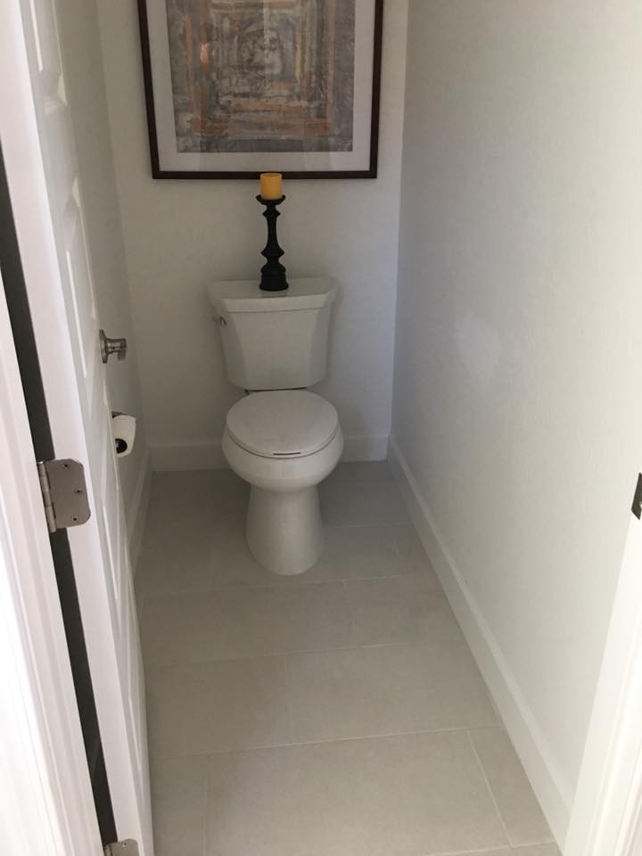 Large-format porcelain tile floor in powder room
